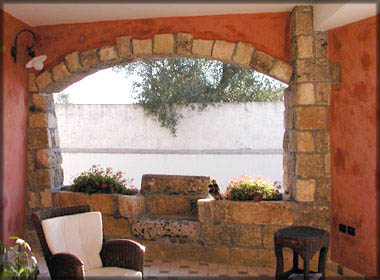 Patio with tuff seat and rustic cladding